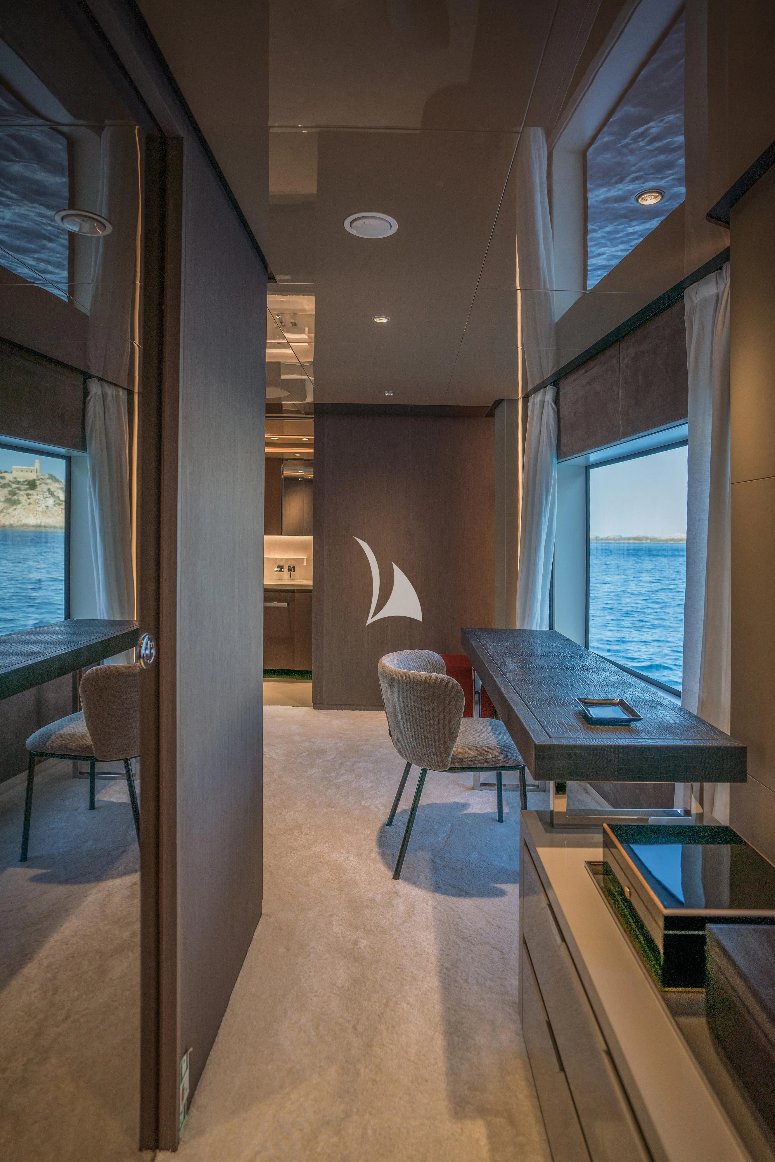 a room with a table and chairs aboard ALVIUM Yacht for Sale