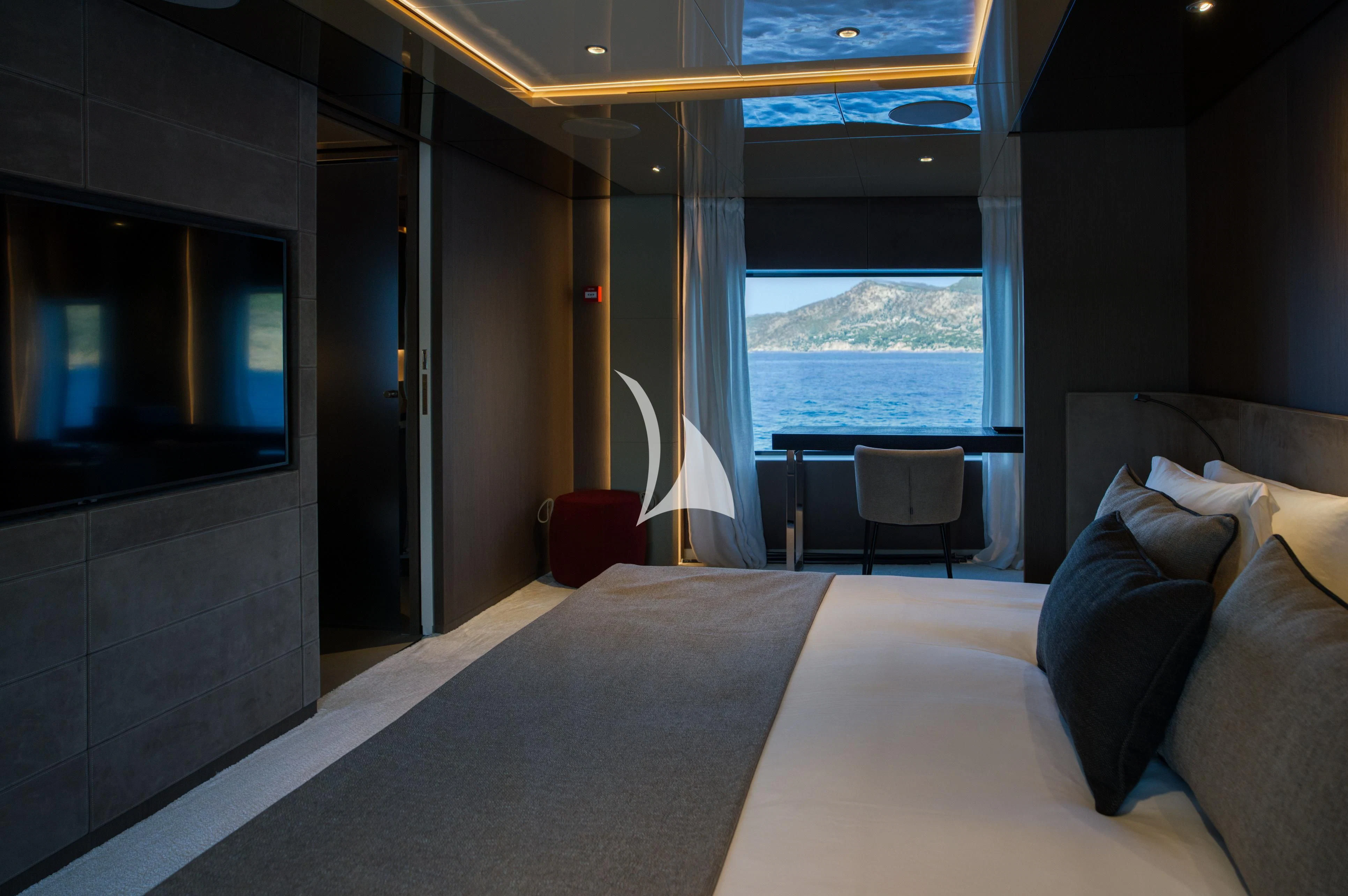 a room with a bed and a tv aboard ALVIUM Yacht for Sale