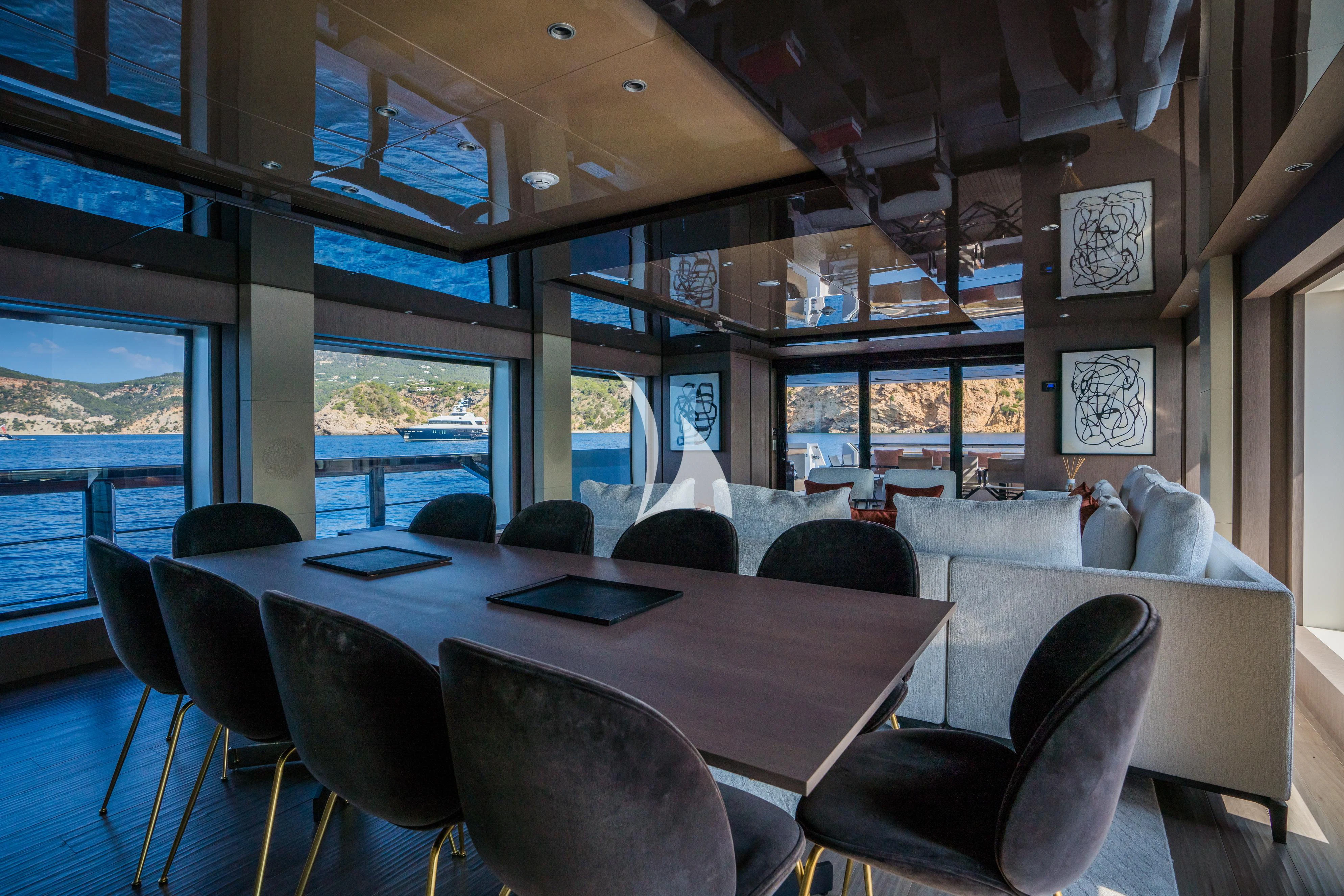 a room with a table and chairs aboard ALVIUM Yacht for Sale