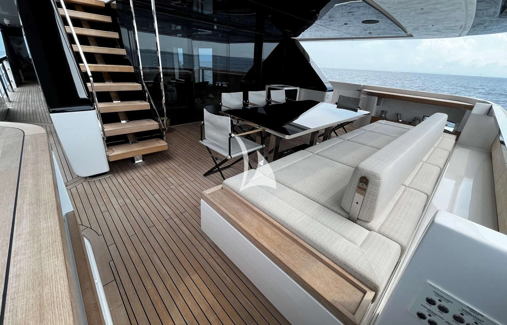 a room with a large bed and a table and chairs aboard ALVIUM Yacht for Sale