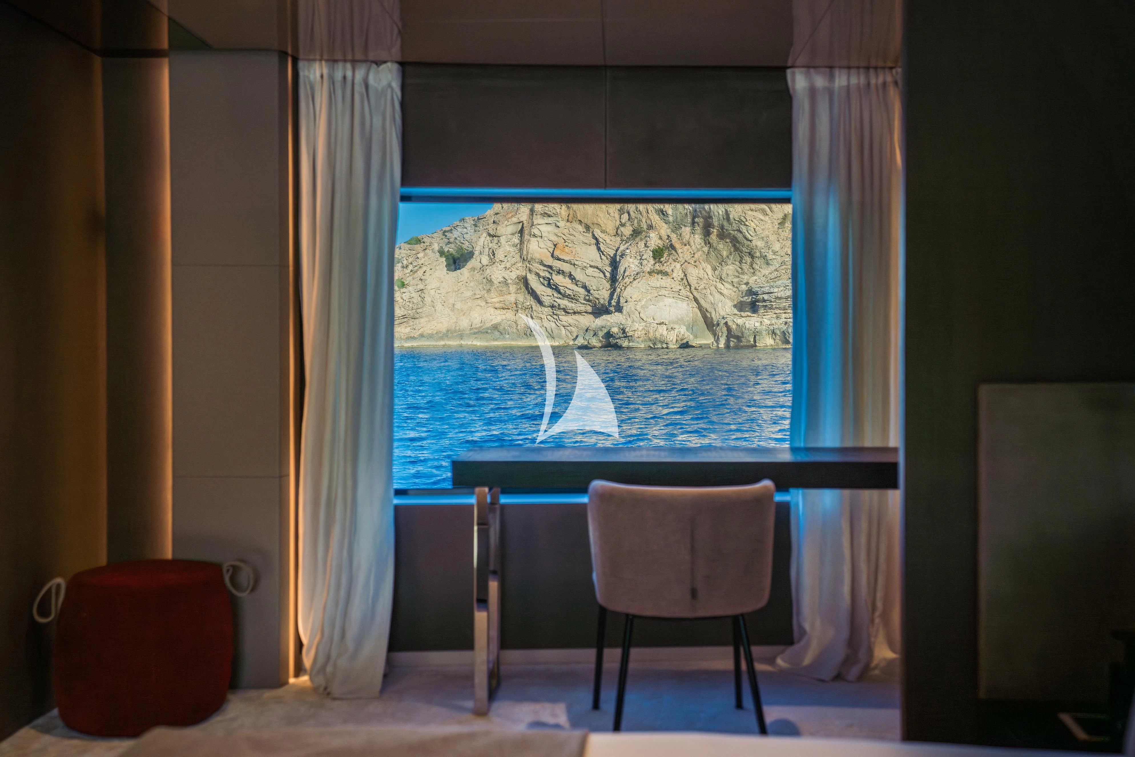 a room with a table and chairs aboard ALVIUM Yacht for Sale