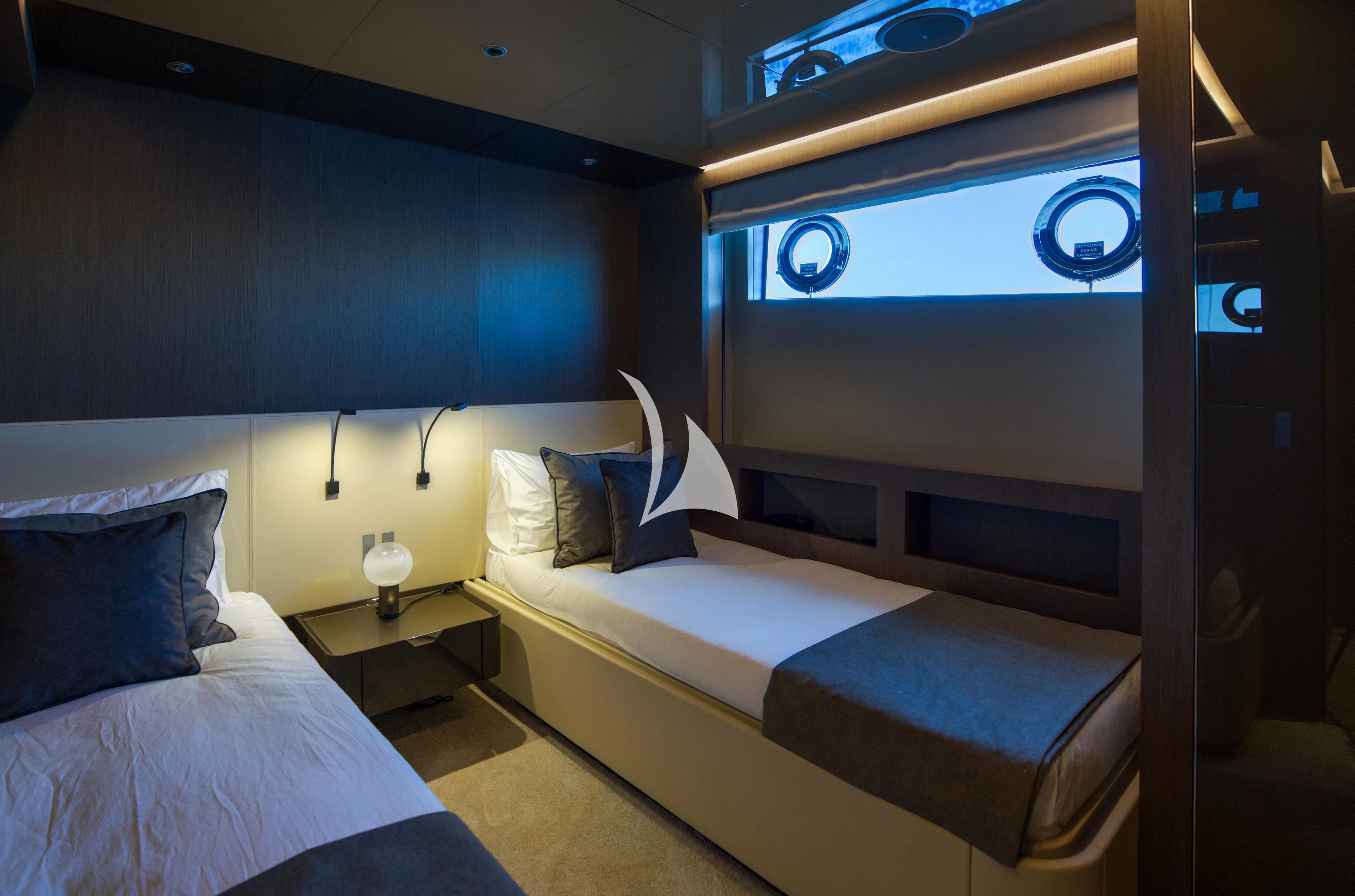a room with a bed and a blue wall aboard ALVIUM Yacht for Sale