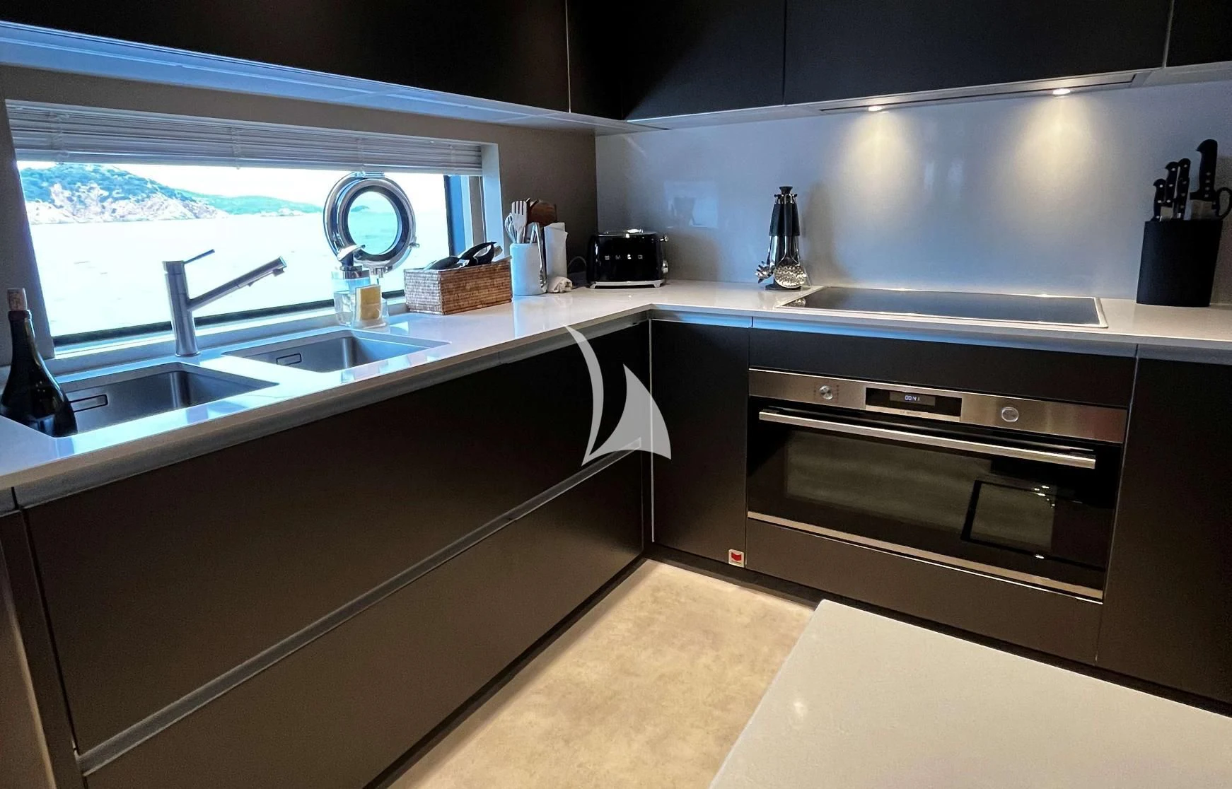 a kitchen with a stove and sink aboard ALVIUM Yacht for Sale