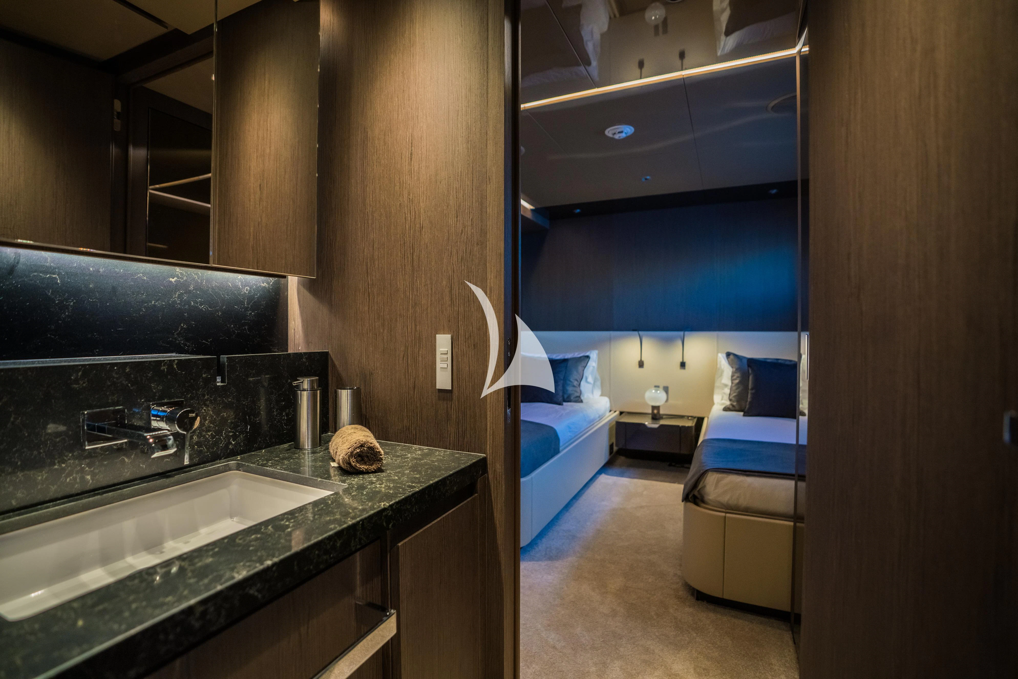 a bathroom with a sink and a bed aboard ALVIUM Yacht for Sale