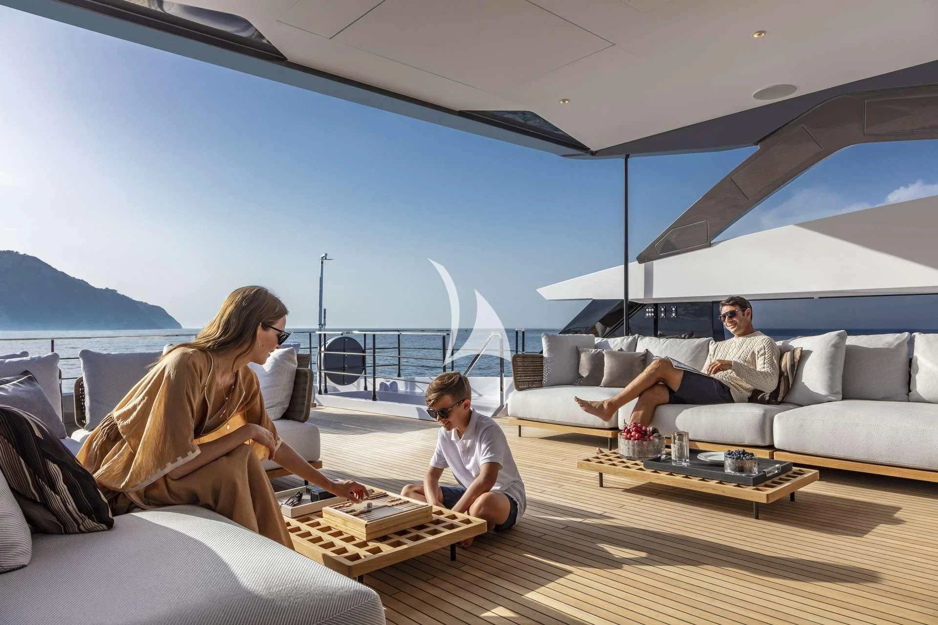 a group of people sitting on a couch aboard ALVIUM Yacht for Sale