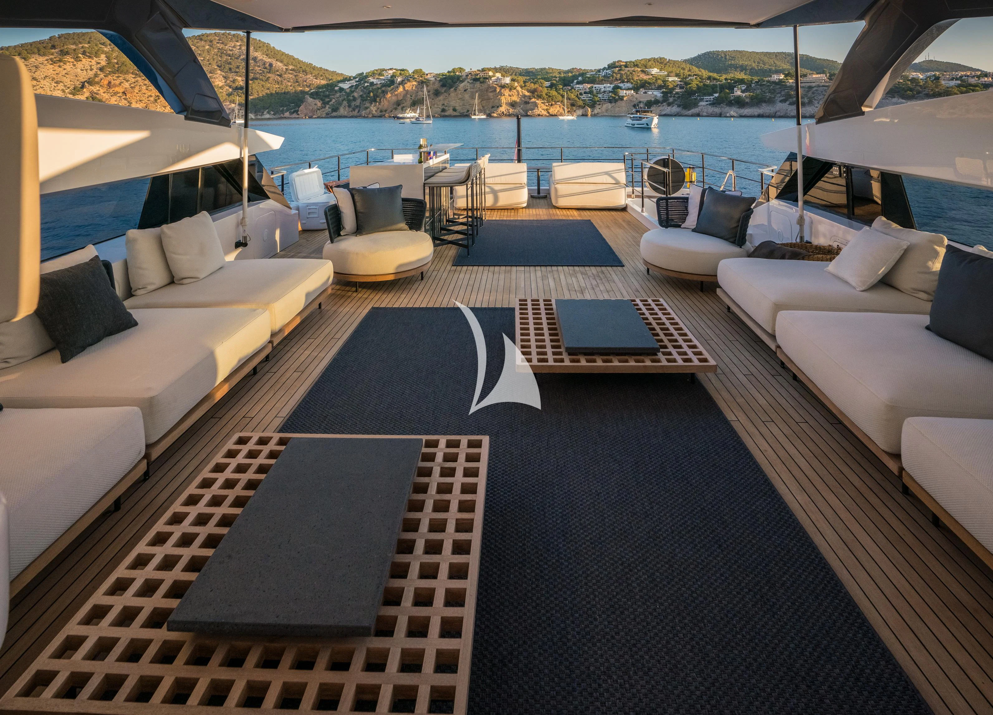 a deck with a view of the ocean and a city aboard ALVIUM Yacht for Sale