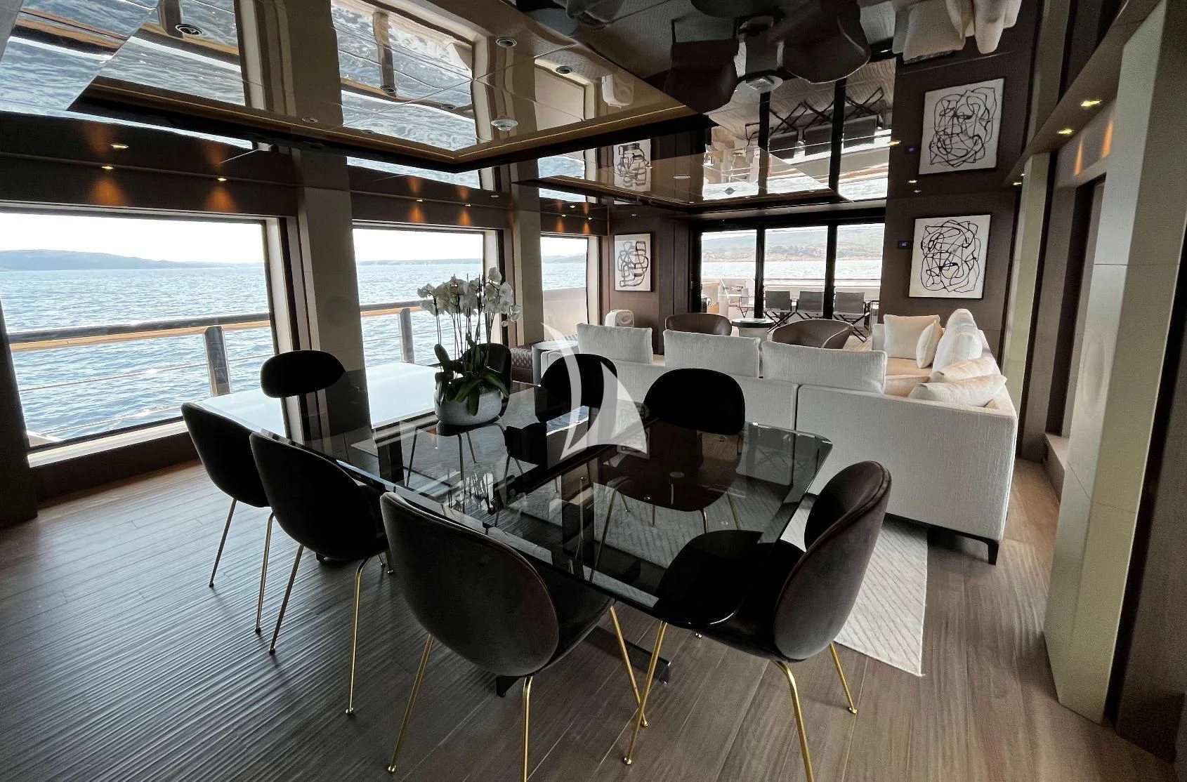 a room with tables and chairs aboard ALVIUM Yacht for Sale