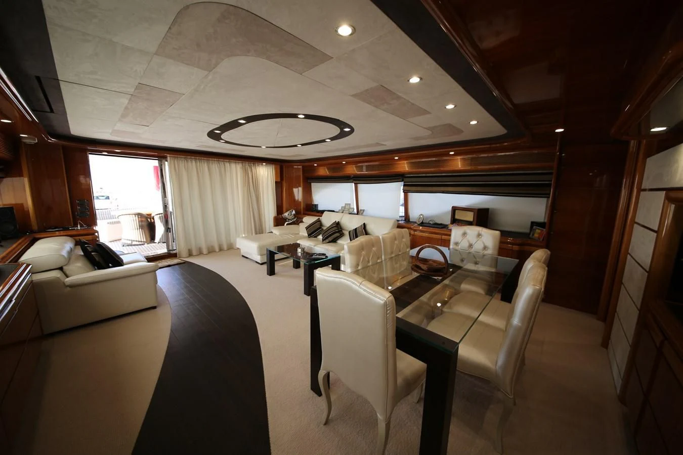 a room with a table chairs and a couch aboard YOLO TOO Yacht for Sale