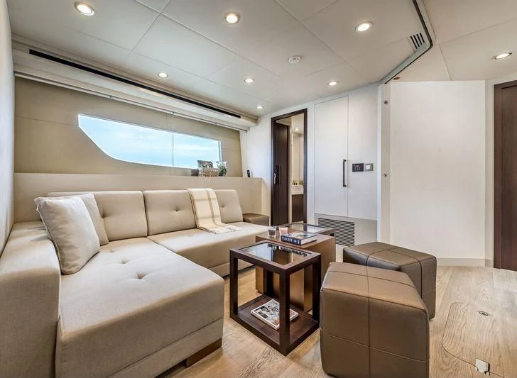 a living room with a couch and a table aboard DOLCE VITA Yacht for Sale
