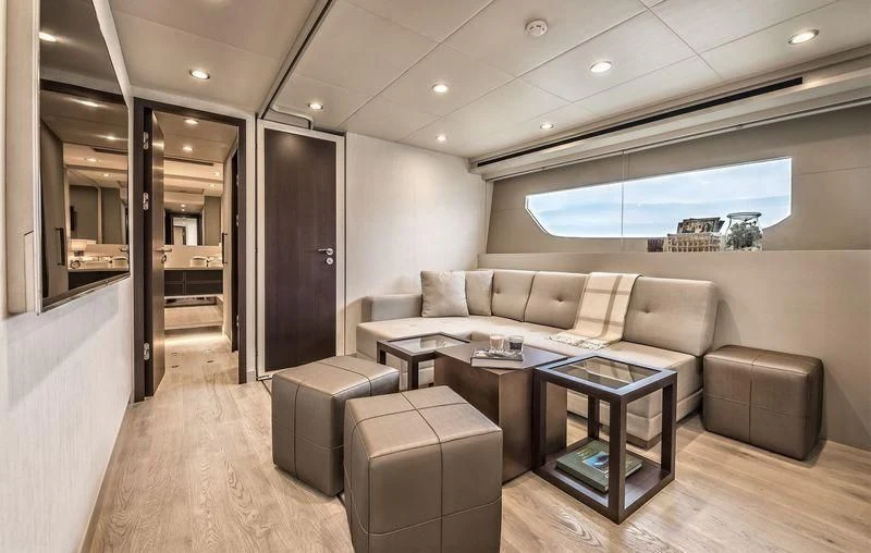 a living room with a couch and a coffee table aboard DOLCE VITA Yacht for Sale