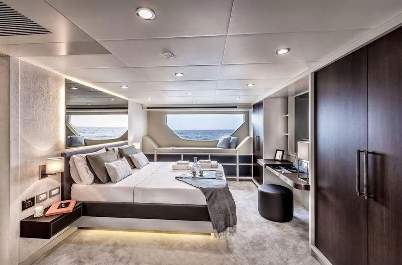 a room with a bed and a desk aboard DOLCE VITA Yacht for Sale