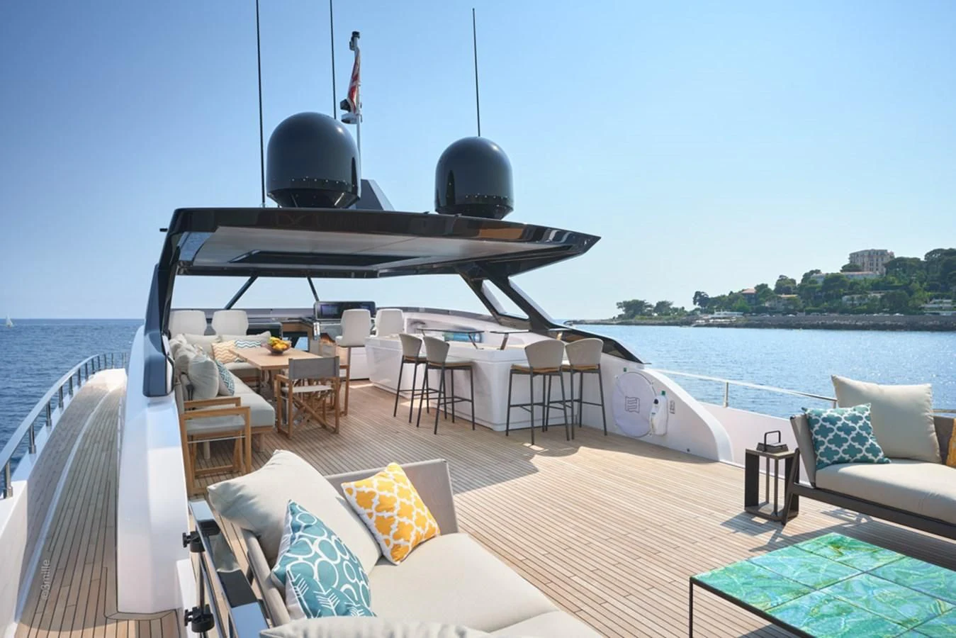 a deck with a table and chairs on it aboard H&CO Yacht for Sale