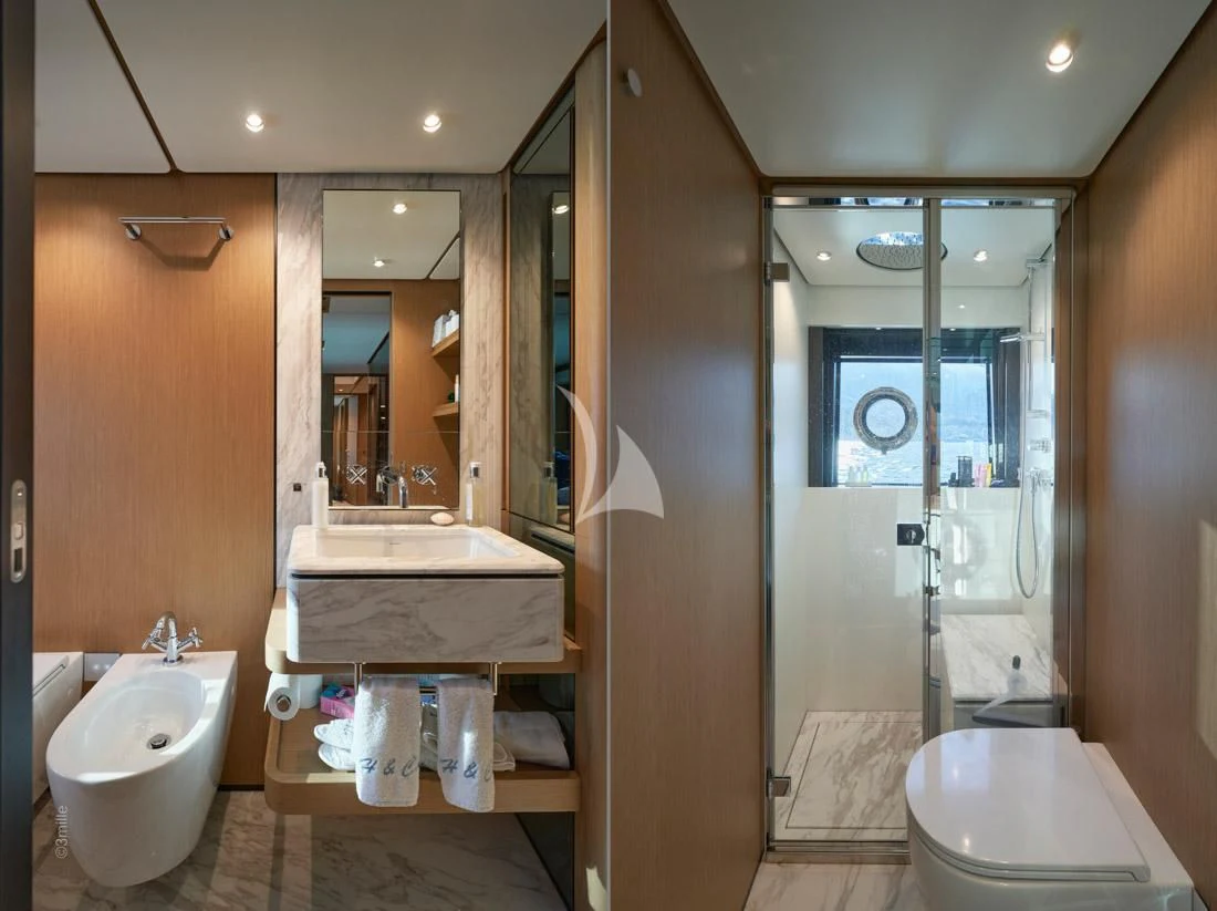 a bathroom with a glass shower aboard H&CO Yacht for Sale