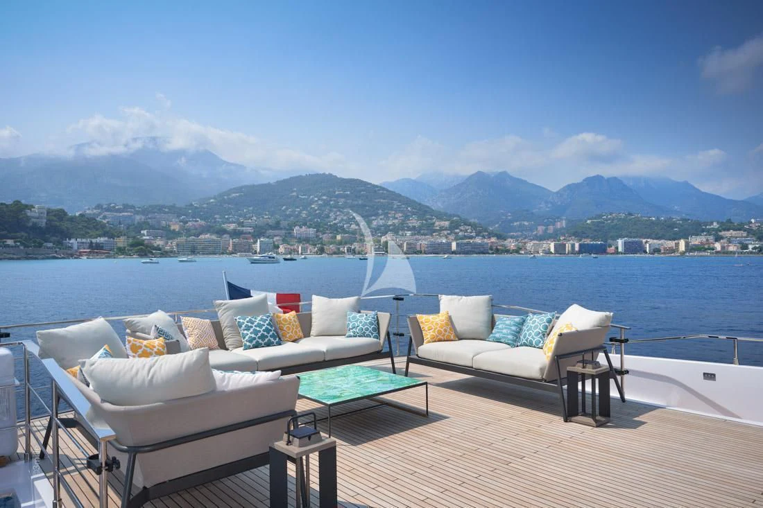 a patio with a table and chairs aboard H&CO Yacht for Sale