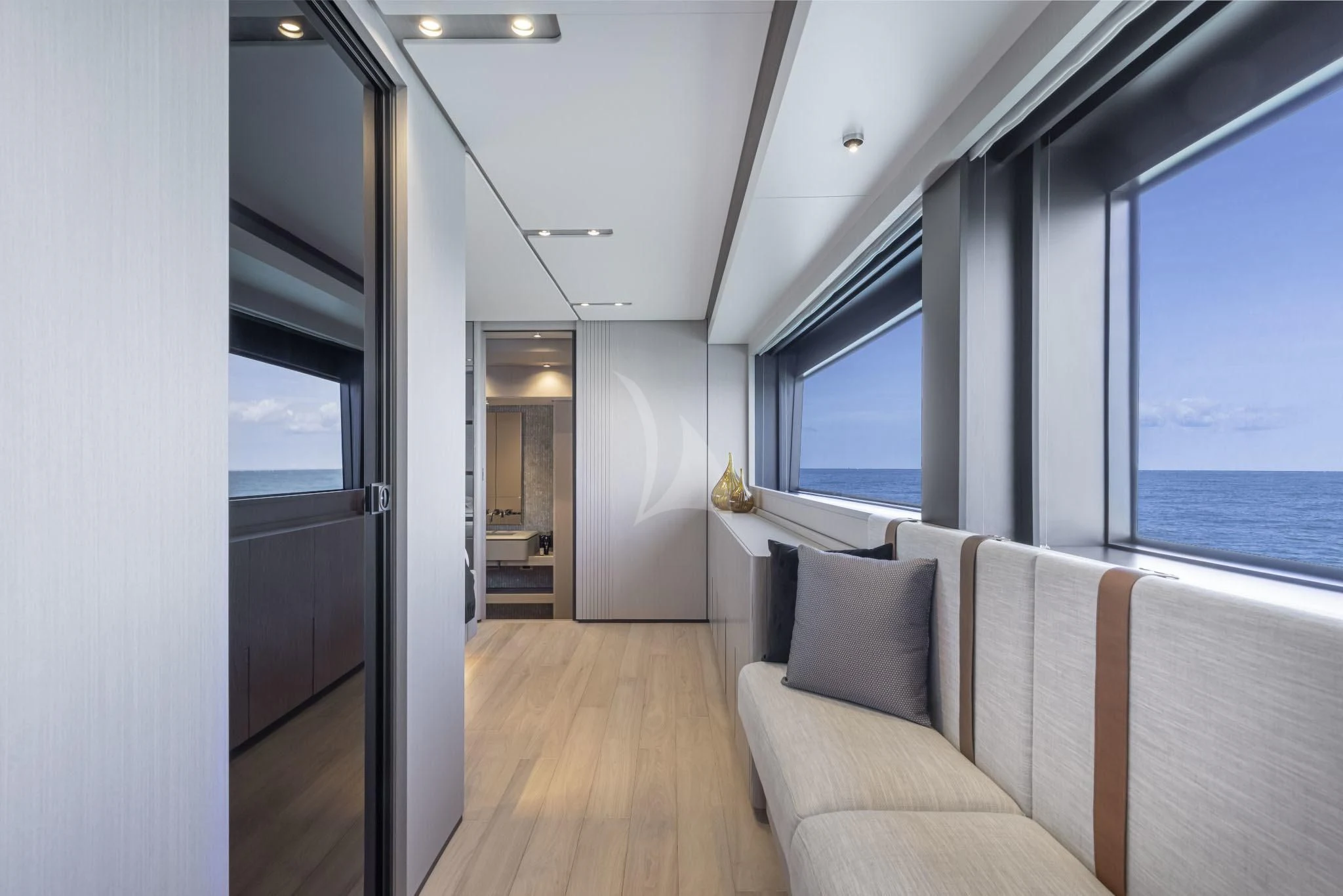 a room with a couch and a large window aboard H&CO Yacht for Sale