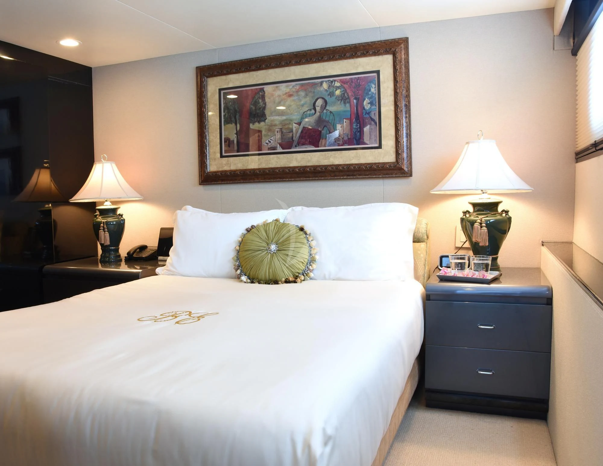 a bedroom with a bed and a lamp aboard BIG EAGLE Yacht for Sale