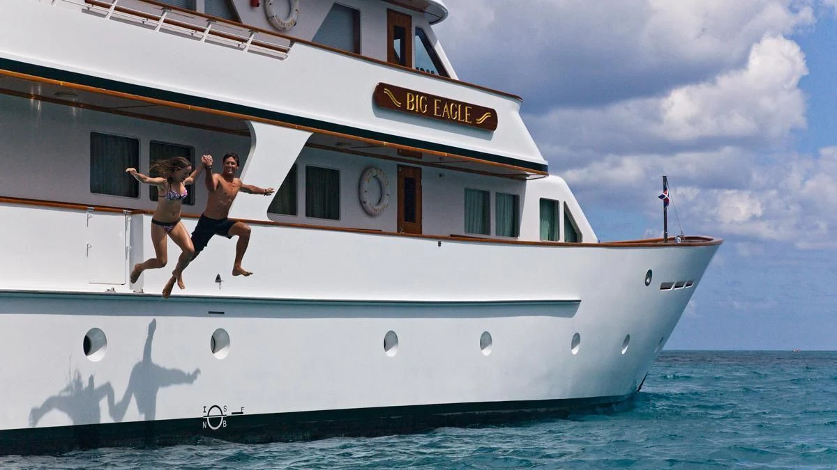 two people jumping in the air on a boat aboard BIG EAGLE Yacht for Sale