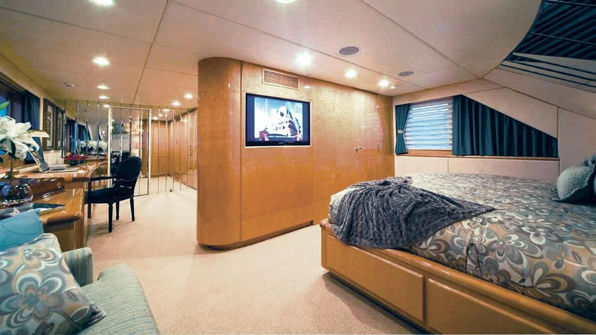 a room with a bed and a tv aboard BIG EAGLE Yacht for Sale