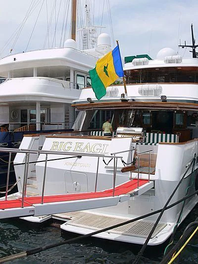 a boat with a flag on the front aboard BIG EAGLE Yacht for Sale