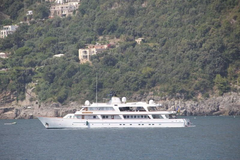 a boat on the water with Mount Athos in the background aboard BIG EAGLE Yacht for Sale
