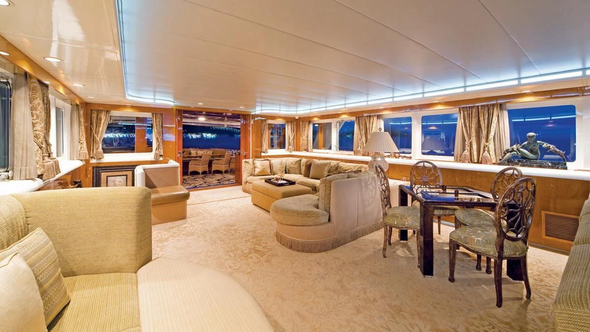 a living room with a large table and chairs aboard BIG EAGLE Yacht for Sale