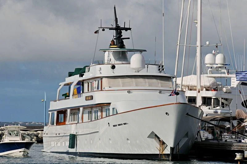 a large white boat in a harbor aboard BIG EAGLE Yacht for Sale