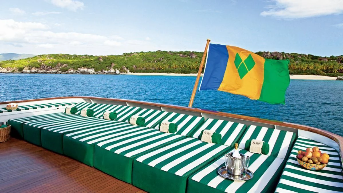 a large green and yellow tent on a deck next to a body of water aboard BIG EAGLE Yacht for Sale