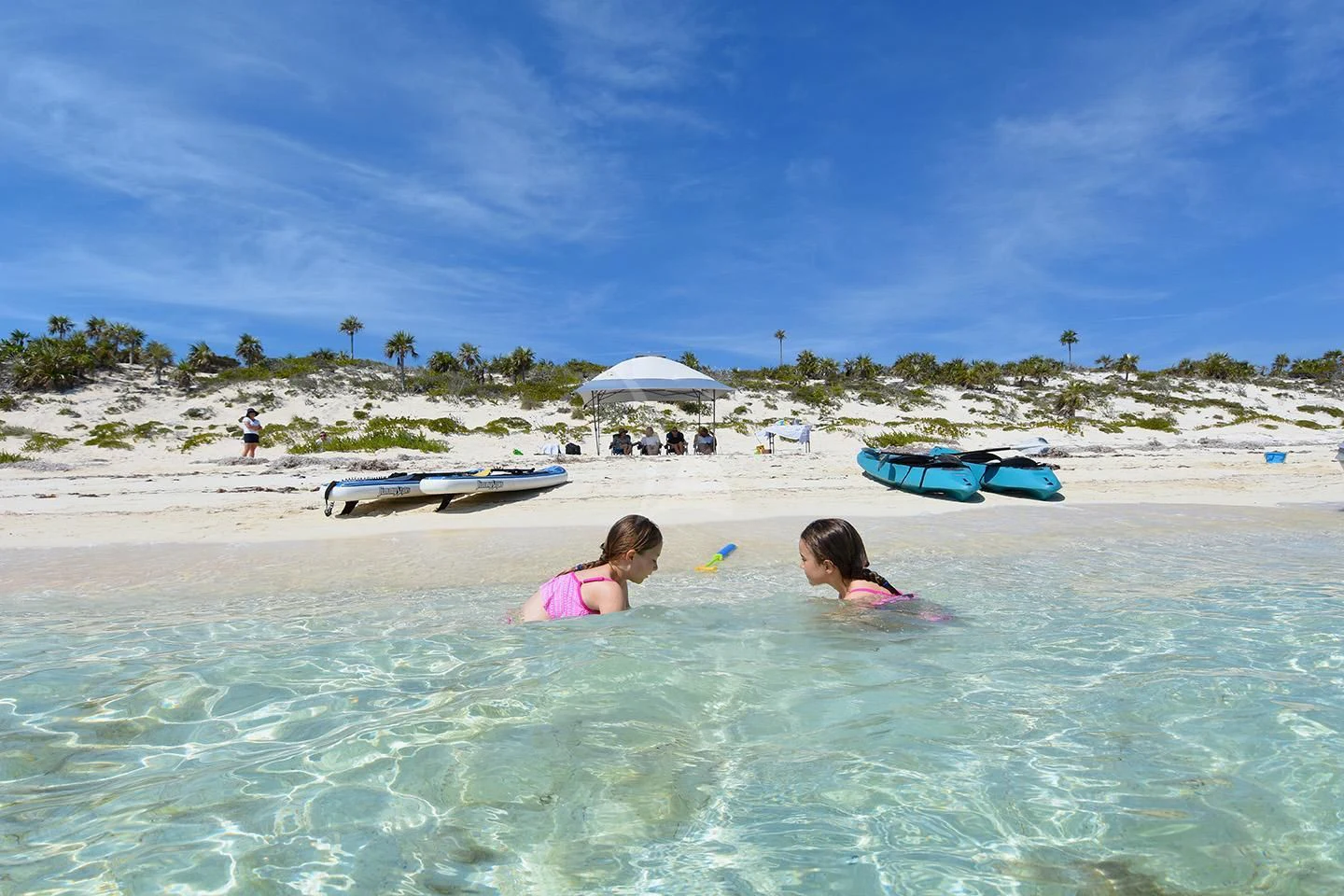 a couple of children playing in the water at a beach aboard BIG EAGLE Yacht for Sale