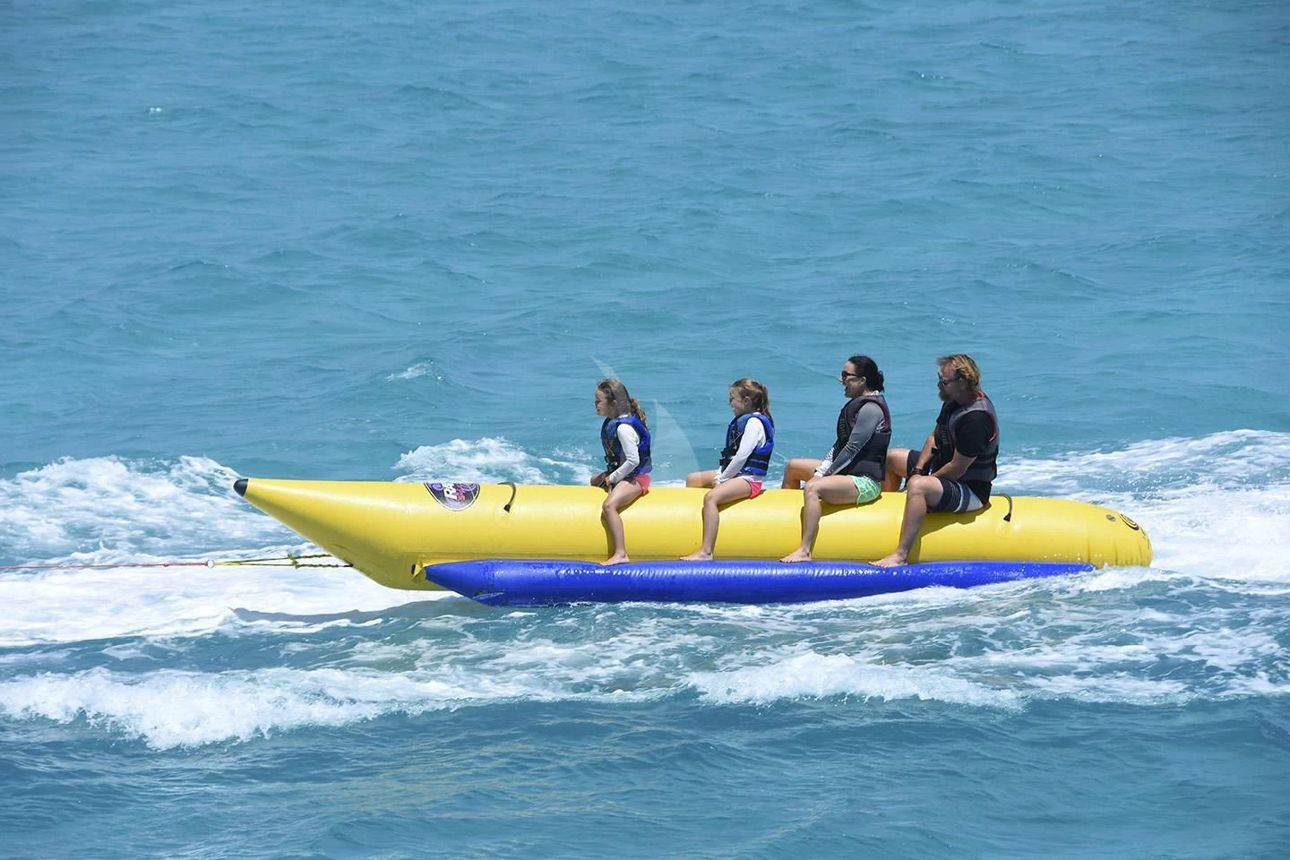 a group of people on a yellow raft in the ocean aboard BIG EAGLE Yacht for Sale