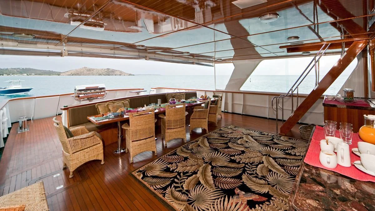 a room with a table and chairs aboard BIG EAGLE Yacht for Sale