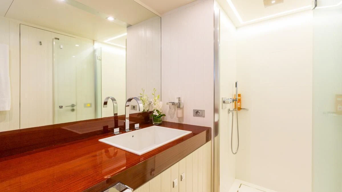 a bathroom with a sink and a mirror aboard BLUE DEVIL Yacht for Sale