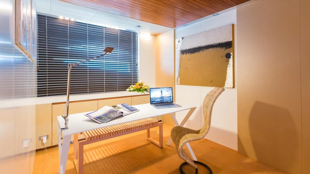 a desk with a laptop on it aboard BLUE DEVIL Yacht for Sale