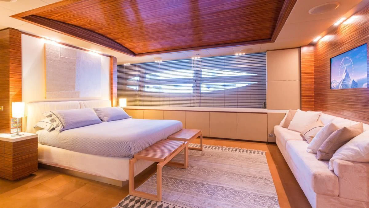 a room with a bed and a table aboard BLUE DEVIL Yacht for Sale