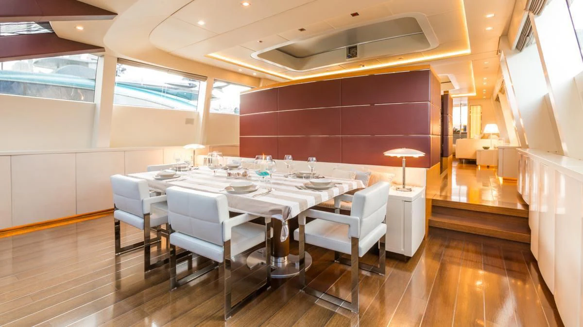 a room with tables and chairs aboard BLUE DEVIL Yacht for Sale
