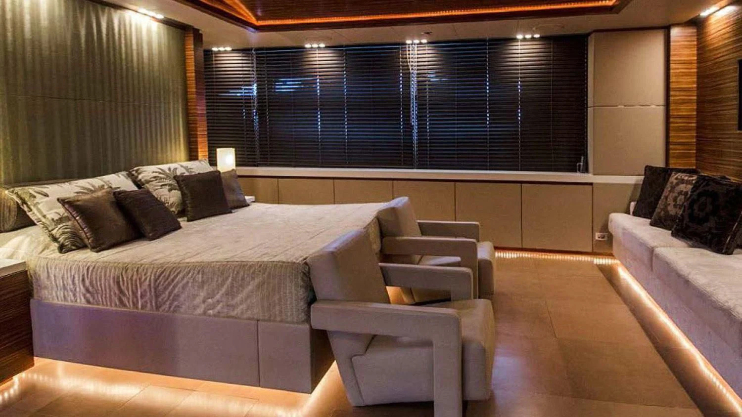 a room with a bed and a chair aboard BLUE DEVIL Yacht for Sale