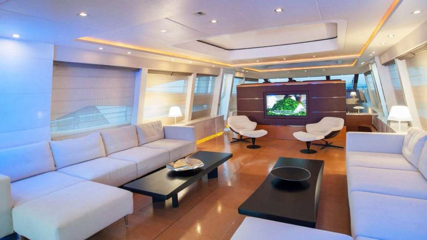 a living room with a large screen aboard BLUE DEVIL Yacht for Sale