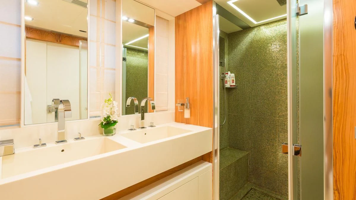 a bathroom with a green shower aboard BLUE DEVIL Yacht for Sale
