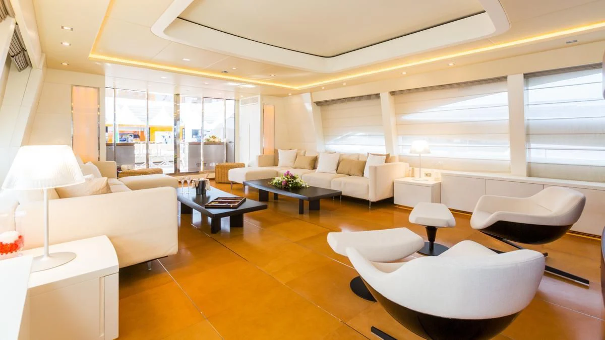 a large living room with white furniture aboard BLUE DEVIL Yacht for Sale
