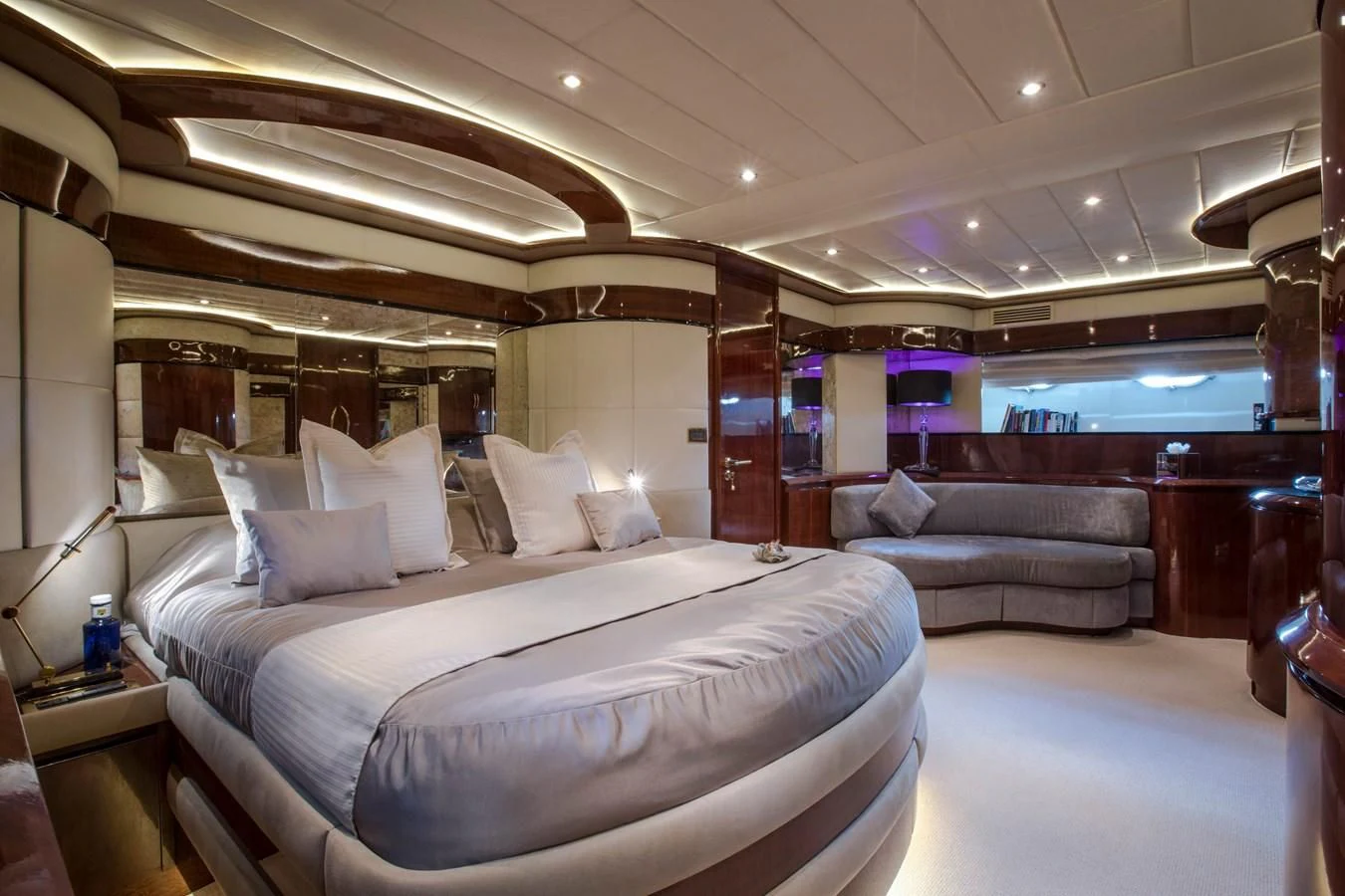 a large room with a bed and a couch aboard SERAPH PRIMERO Yacht for Sale