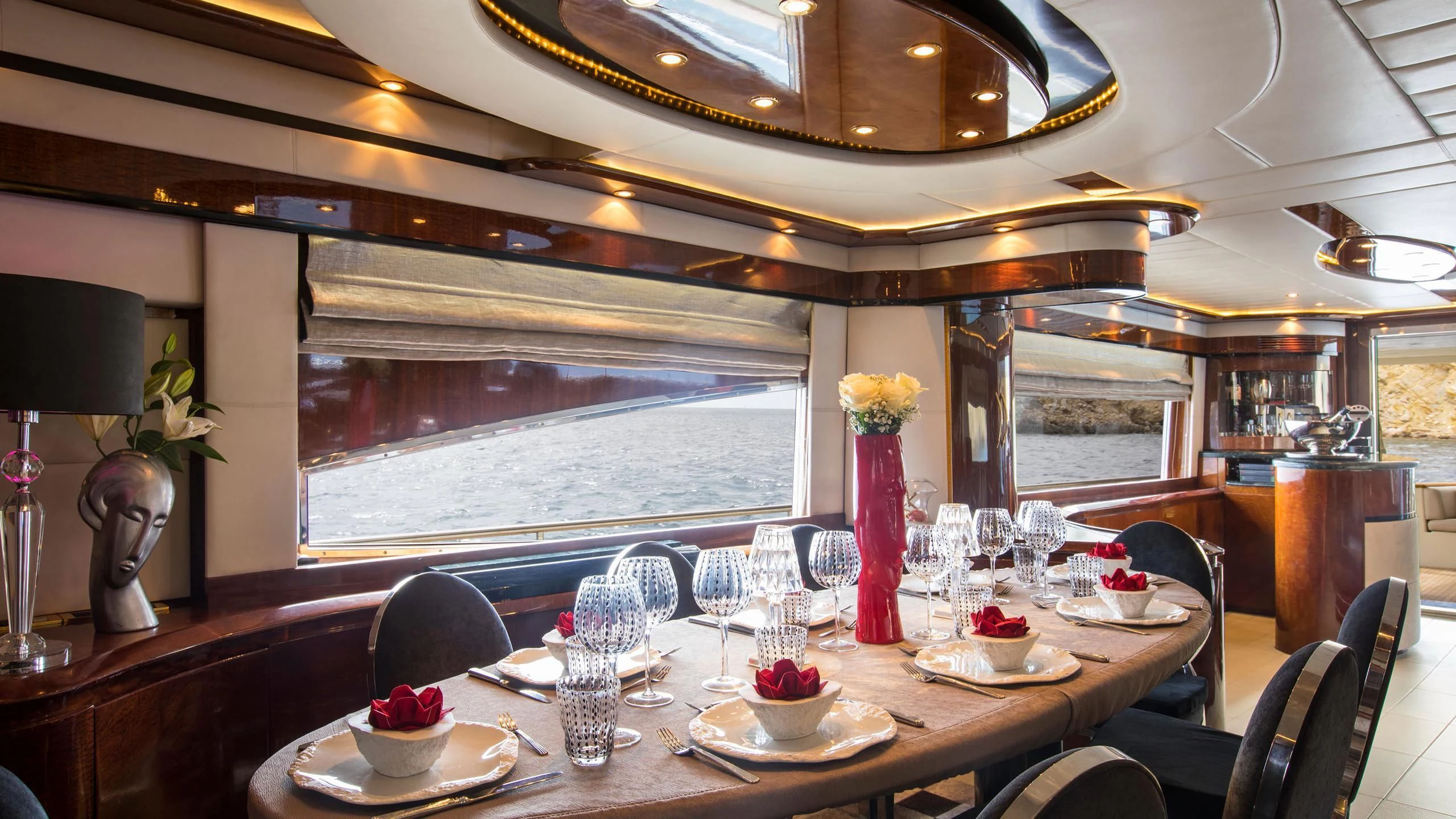 a table set with wine glasses and flowers aboard SERAPH PRIMERO Yacht for Sale