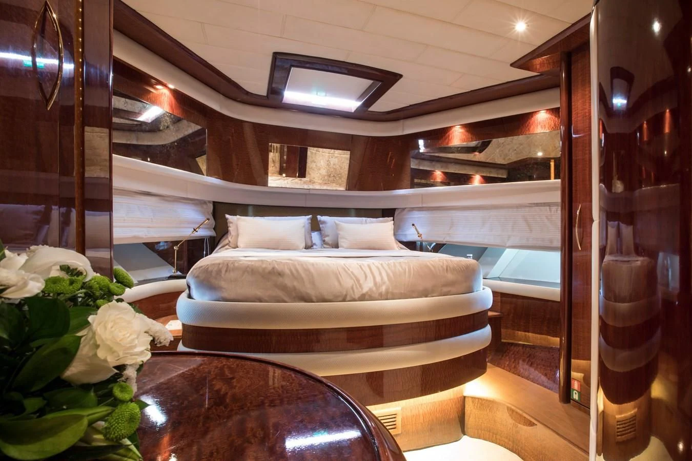 a room with a bed and a table aboard SERAPH PRIMERO Yacht for Sale