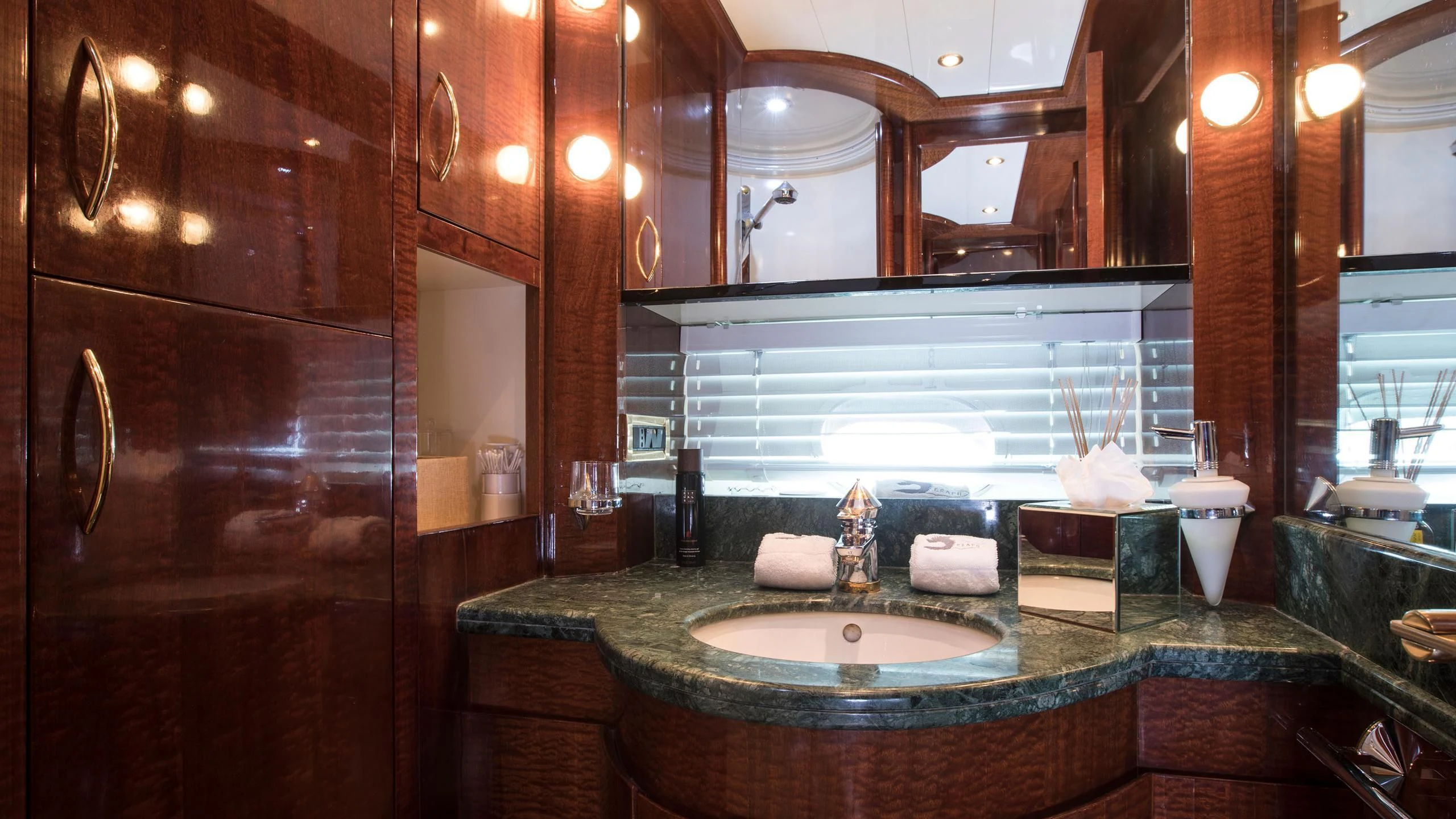 a bathroom with a countertop sink and a large mirror aboard SERAPH PRIMERO Yacht for Sale