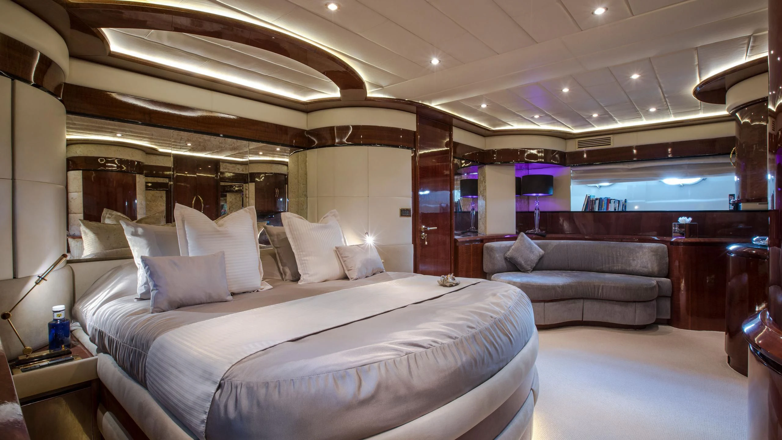 a room with a bed and a couch aboard SERAPH PRIMERO Yacht for Sale