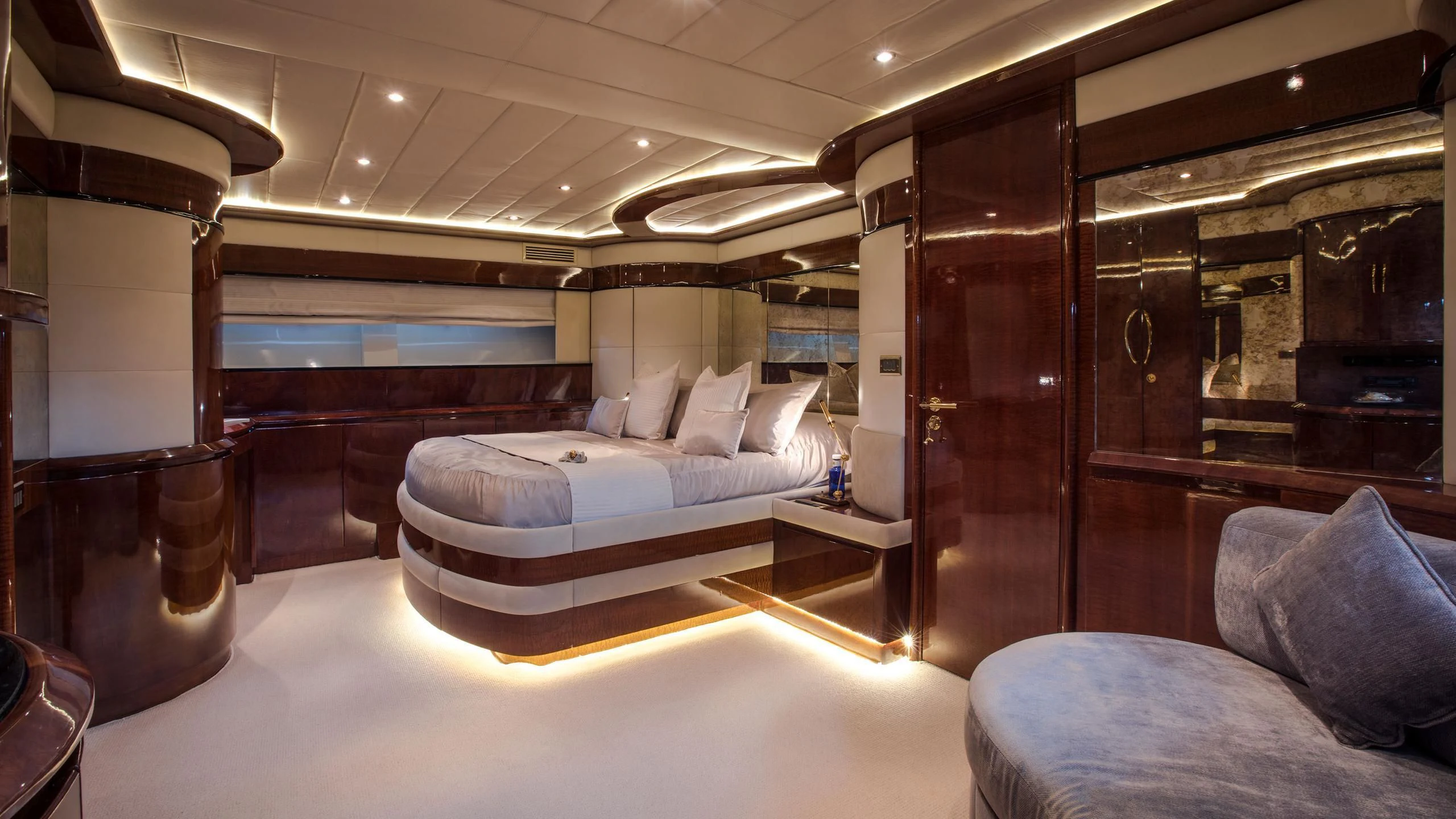 a large room with a bed and a couch aboard SERAPH PRIMERO Yacht for Sale