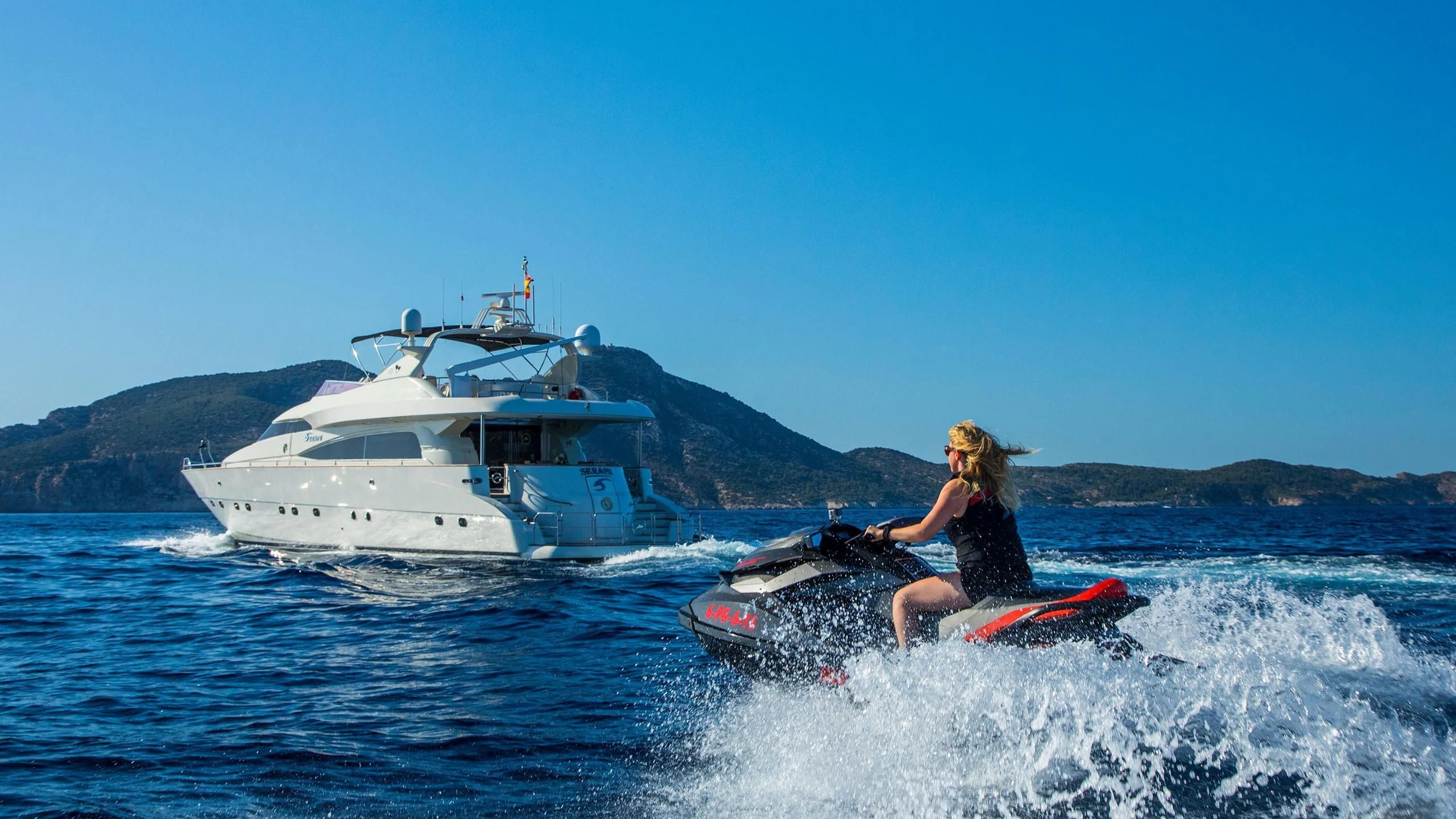 a man surfing in the sea aboard SERAPH PRIMERO Yacht for Sale