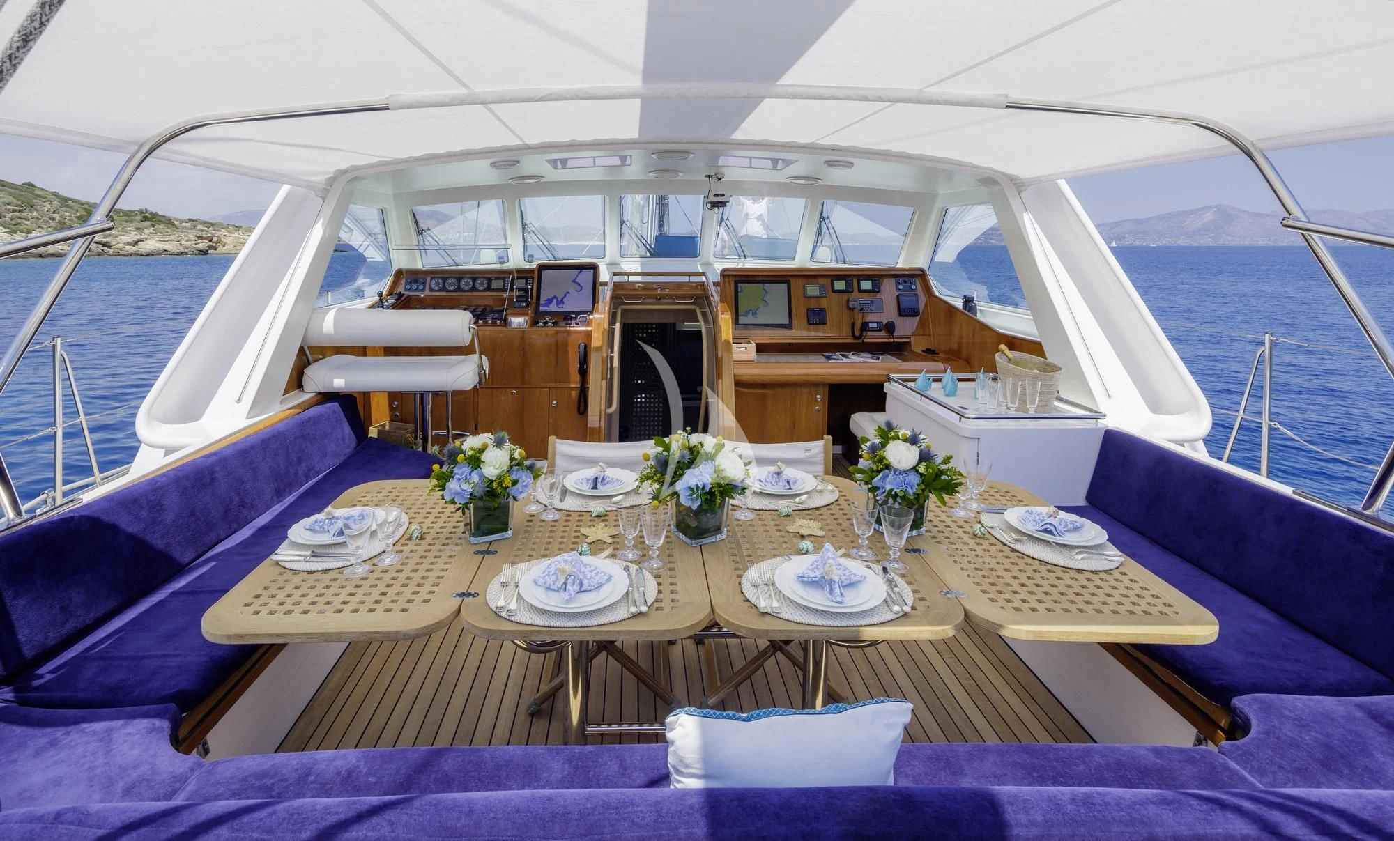 a table with plates and food on it aboard NOMMO Yacht for Sale