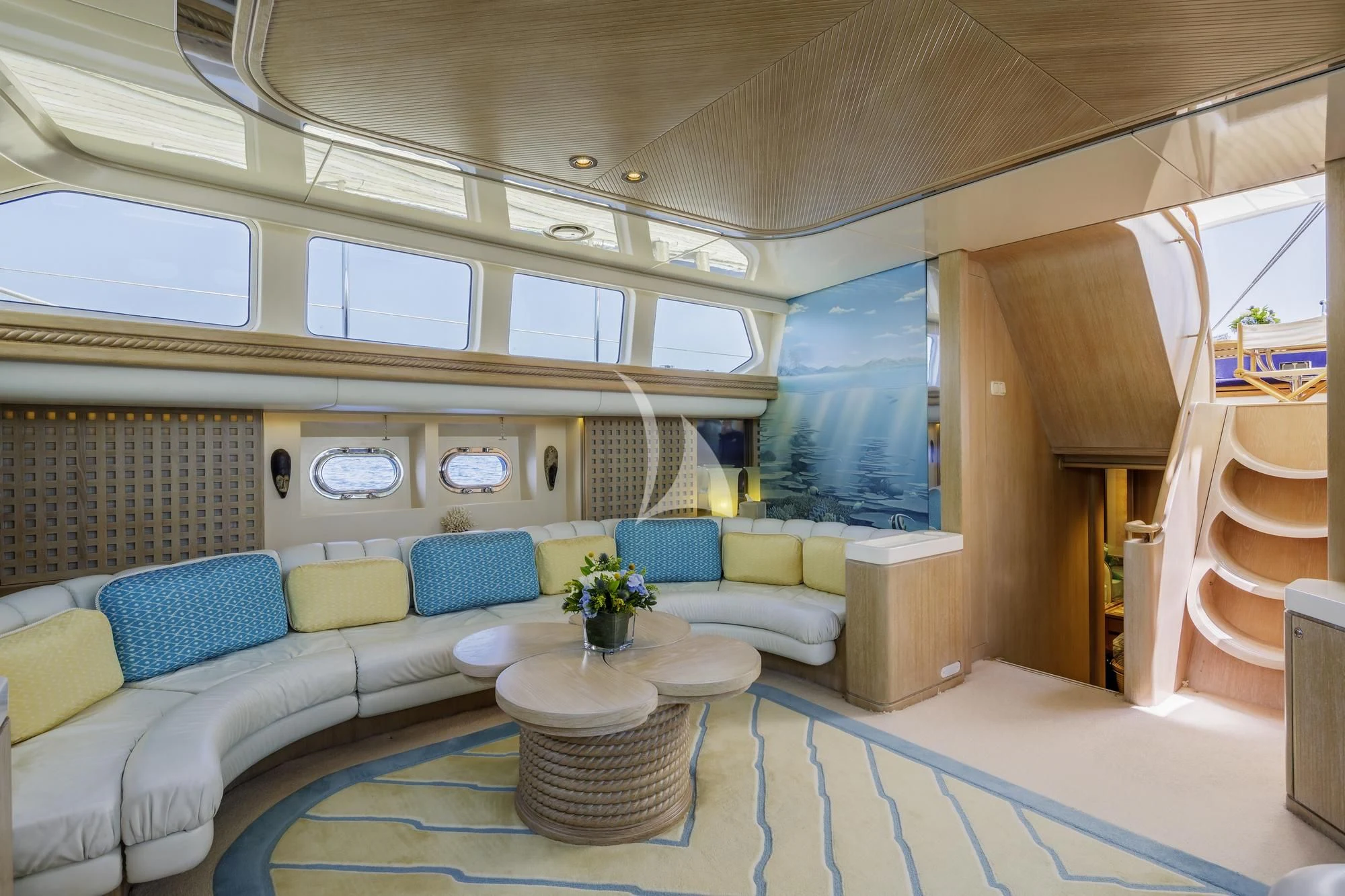 a living room with a couch and a table aboard NOMMO Yacht for Sale
