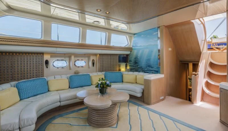 a large room with a couch and a table aboard NOMMO Yacht for Sale