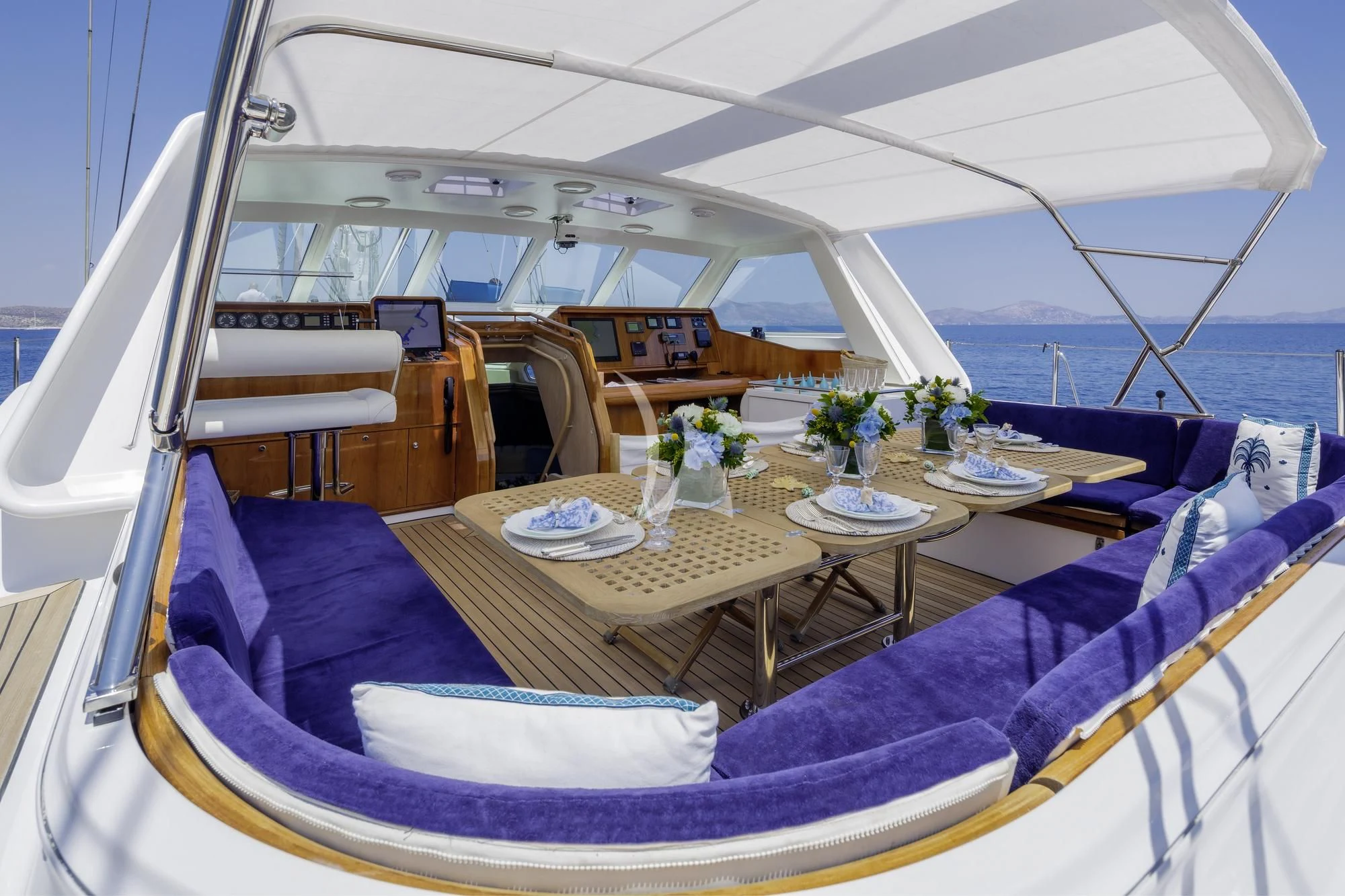 a tent with a table and chairs aboard NOMMO Yacht for Sale