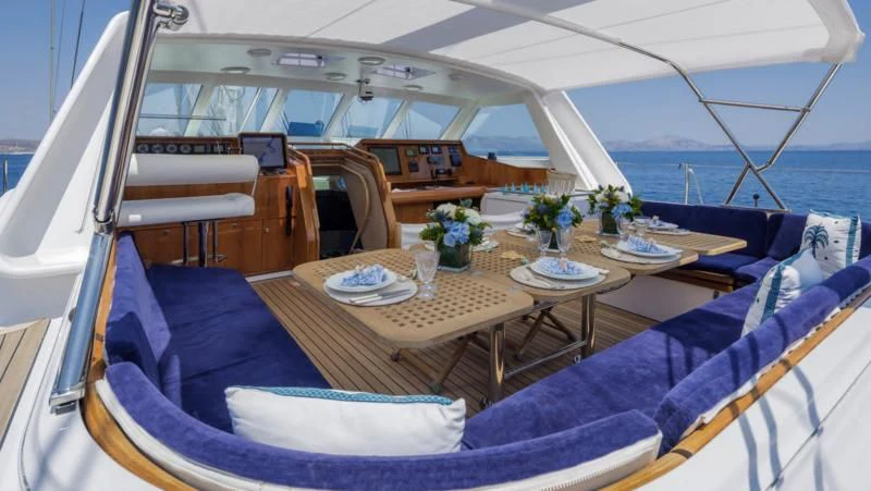 a boat with a table and chairs aboard NOMMO Yacht for Sale